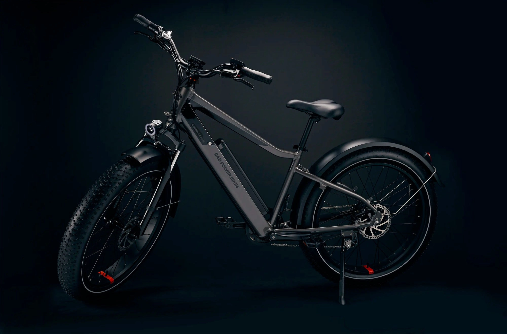 A black Rad ebike lit against a dark studio background